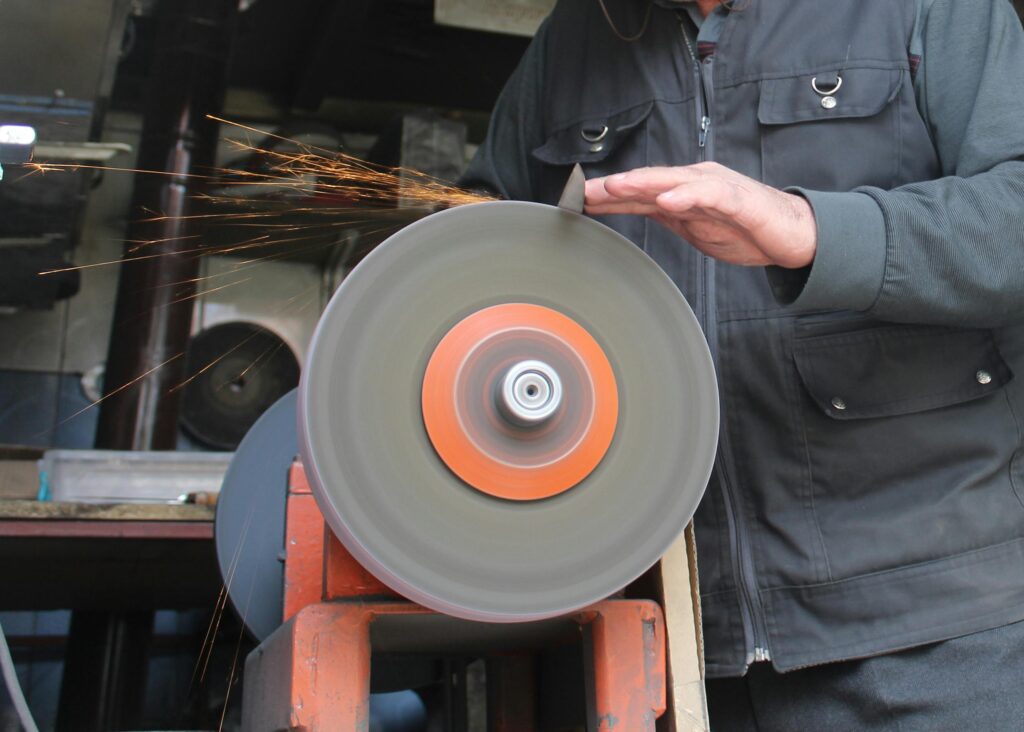 Man Grinding in a Workshop