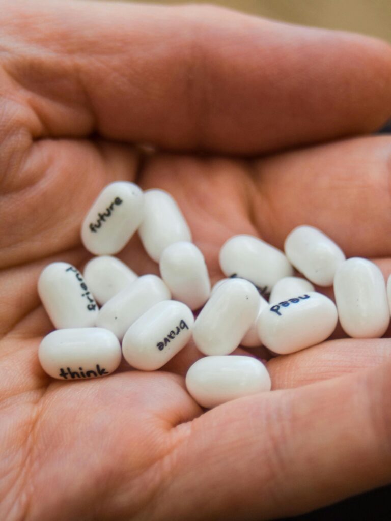 A close-up of hands holding motivational words on white Tic Tac candies.