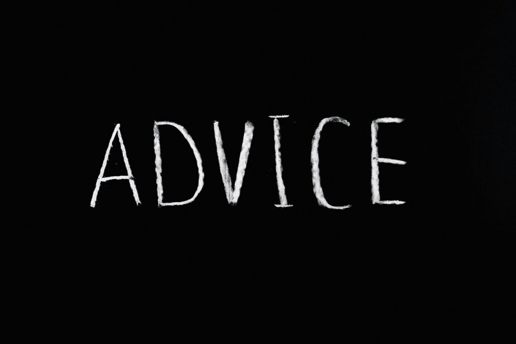 Inspirational word 'Advice' written in white chalk on blackboard.