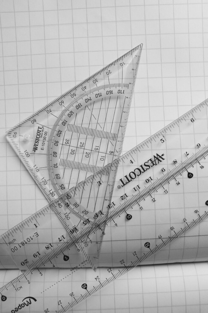 pexels-photo-29279398-29279398 Clear plastic rulers and a protractor on graph paper, ideal for math and school subjects.