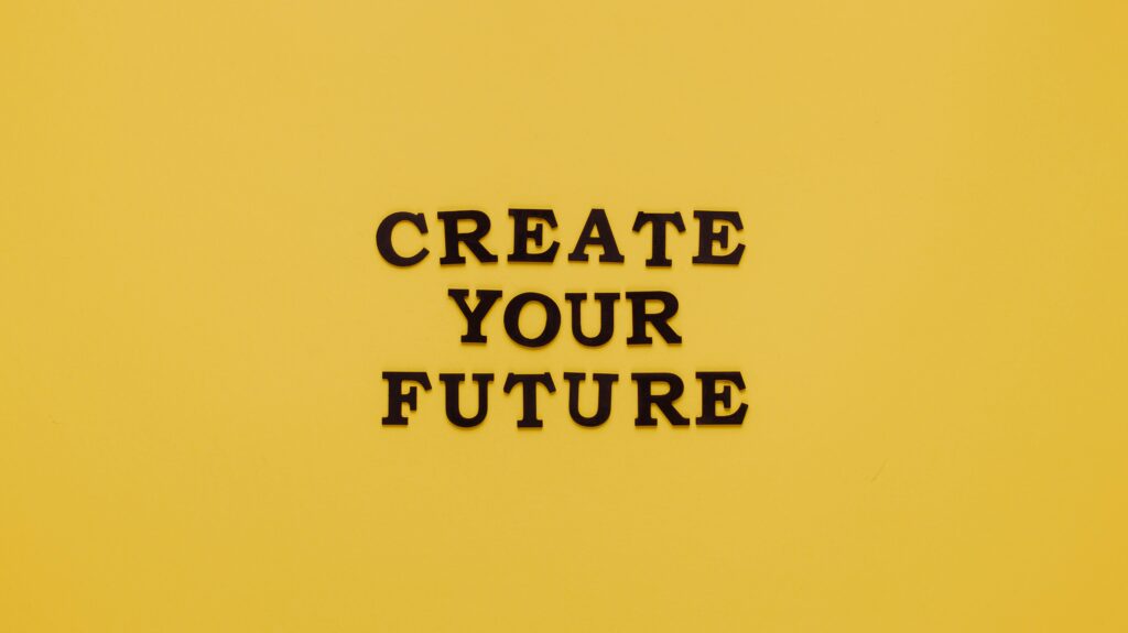 pexels-photo-5981782-5981782 Bold text 'CREATE YOUR FUTURE' on minimalist yellow background. Inspiring design.