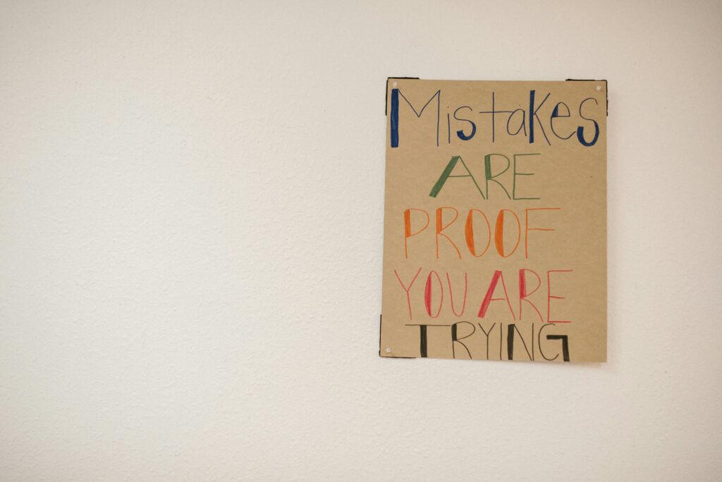 pexels-photo-6936081-6936081 A motivational poster with the phrase 'Mistakes are proof you are trying.'