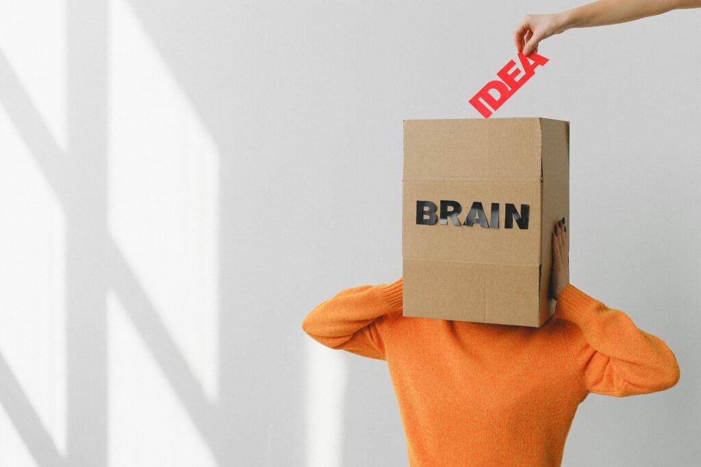 pexels-photo-7203727-7203727 Surreal image of a person with a cardboard brain, symbolizing idea and intellect.