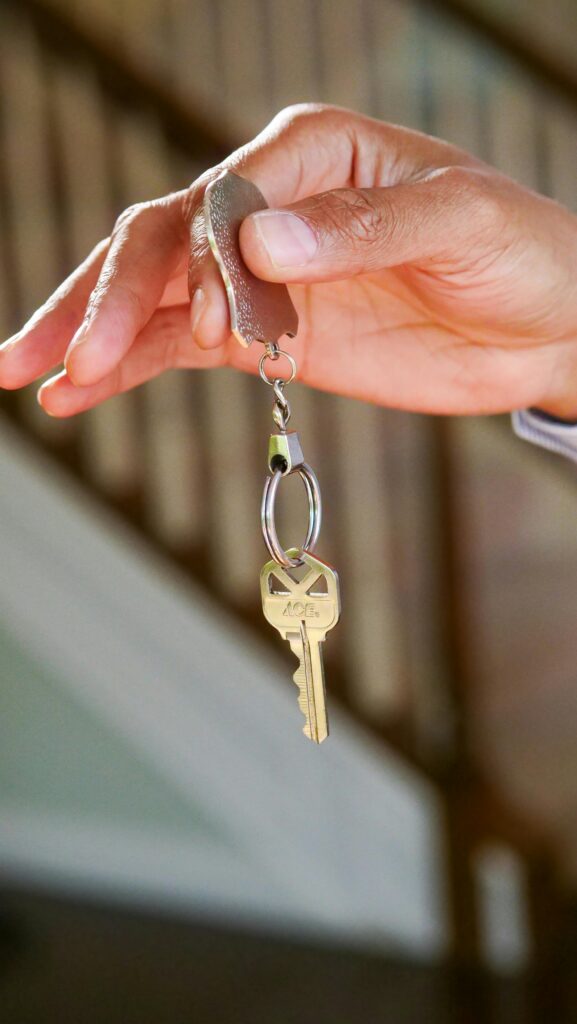 pexels-photo-7578984-7578984 Close-up of a hand holding a key, symbolizing new homeownership or rental.