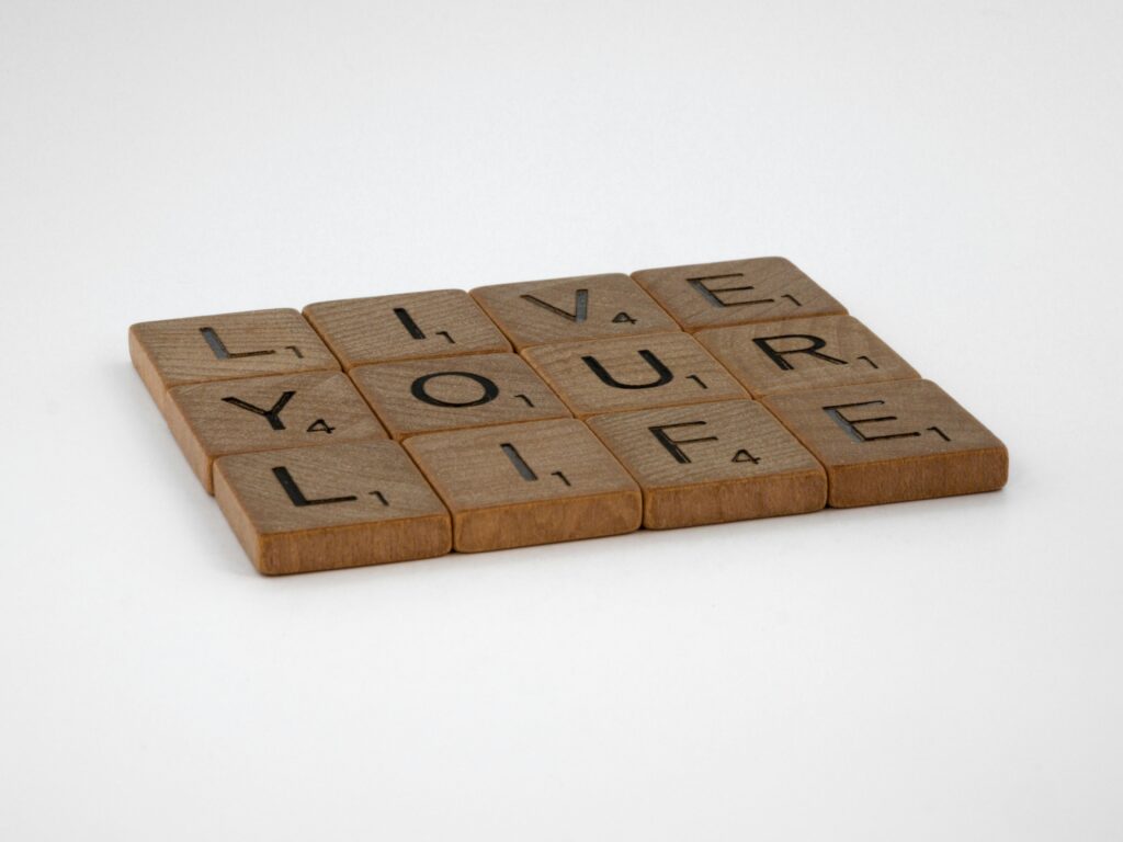 pexels-photo-9046697-9046697 Wooden Scrabble tiles spell out 'Live Your Life' on a white surface. Encouraging and minimalist.