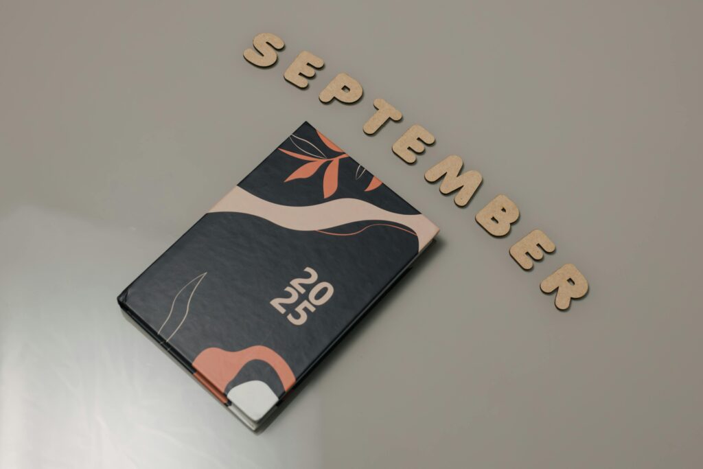 Stylish 2025 planner next to 'September' text, perfect for organization.