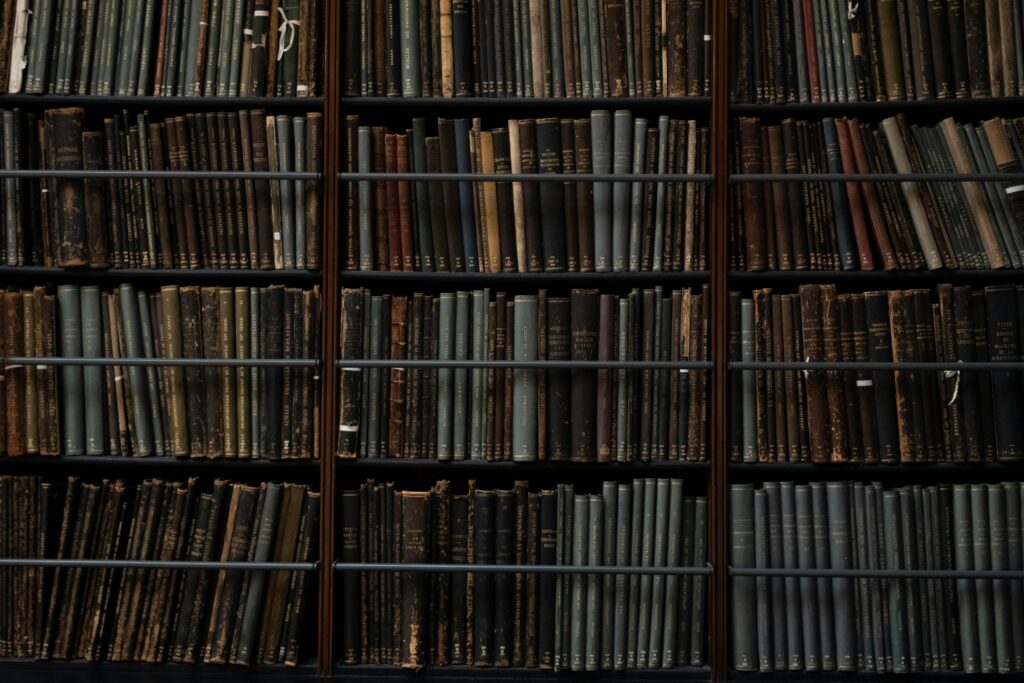 A close-up of vintage books on library shelves in London, showcasing an abundance of literary history.